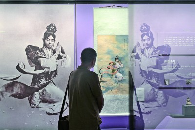 观众在北京恭王府博物馆内参观梅兰芳在京剧《天女散花》中的剧照（左）和徐悲鸿画作《天女散花》（复制品）。新华社发